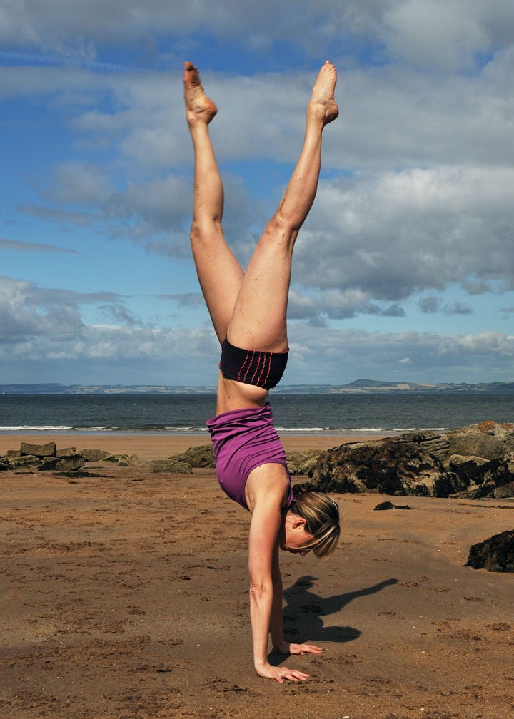 Julie in a handstand on the beach
